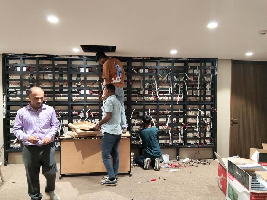 Micro Solutions engineers wiring an LED video wall frame on site
